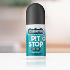 A studio shot of Scrubbingtons Pit Stop Original Deodorant for Kids. The 50ml roll-on bottle features a black cap and a teal label with a '98% Natural' seal, positioned on a white reflective surface against a soft, blurred background