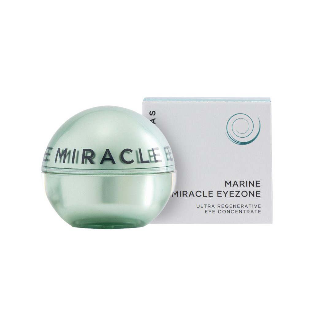 A round translucent pale green cosmetic jar labeled 'MARINE MIRACLE EYE' stands in front of its white and light blue box, which reads 'MARINE MIRACLE EYEZONE ULTRA REGENERATIVE EYE CONCENTRATE'.