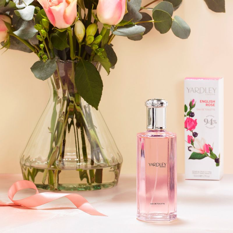 rose bouquet next to perfume.