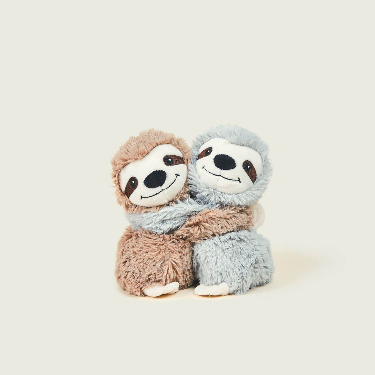 Small brown and grey sloths hugging each other.